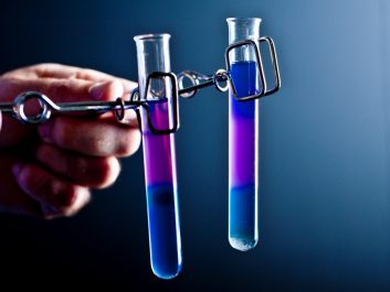 Two_small_test_tubes_held_in_spring_clamps.jpg